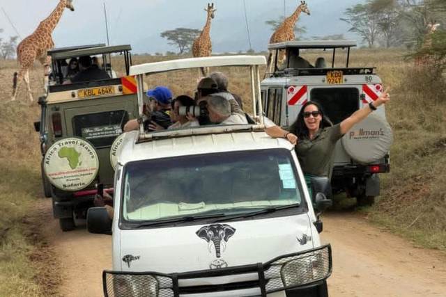 Group of ELMAG SAFARIS safari vans together on a game drive in Kenya