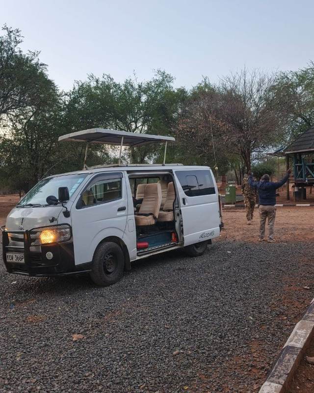 ELMAG SAFARIS pop-top safari van outside a Kenyan safari lodge