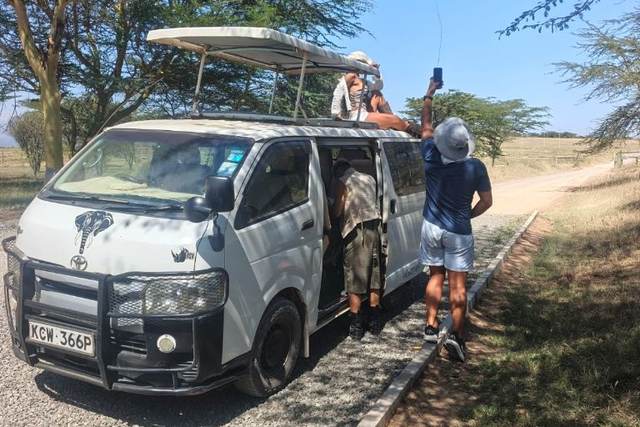 ELMAG SAFARIS pop-top safari van parked on open savanna in Kenya