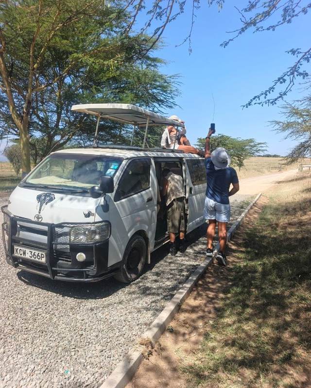 ELMAG SAFARIS pop-top safari van parked on open savanna in Kenya